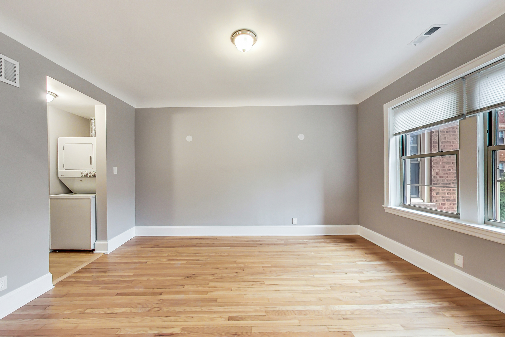 932 Pleasant Street, Unit 2W Oak Park, IL 60302 - Photo 7 of 21 wooden floor in an empty room with a window