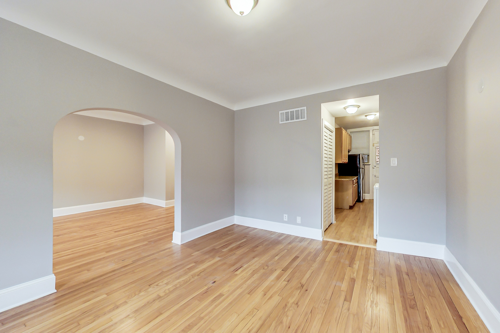 932 Pleasant Street, Unit 2W Oak Park, IL 60302 - Photo 9 of 21 wooden floor in an empty room with a window