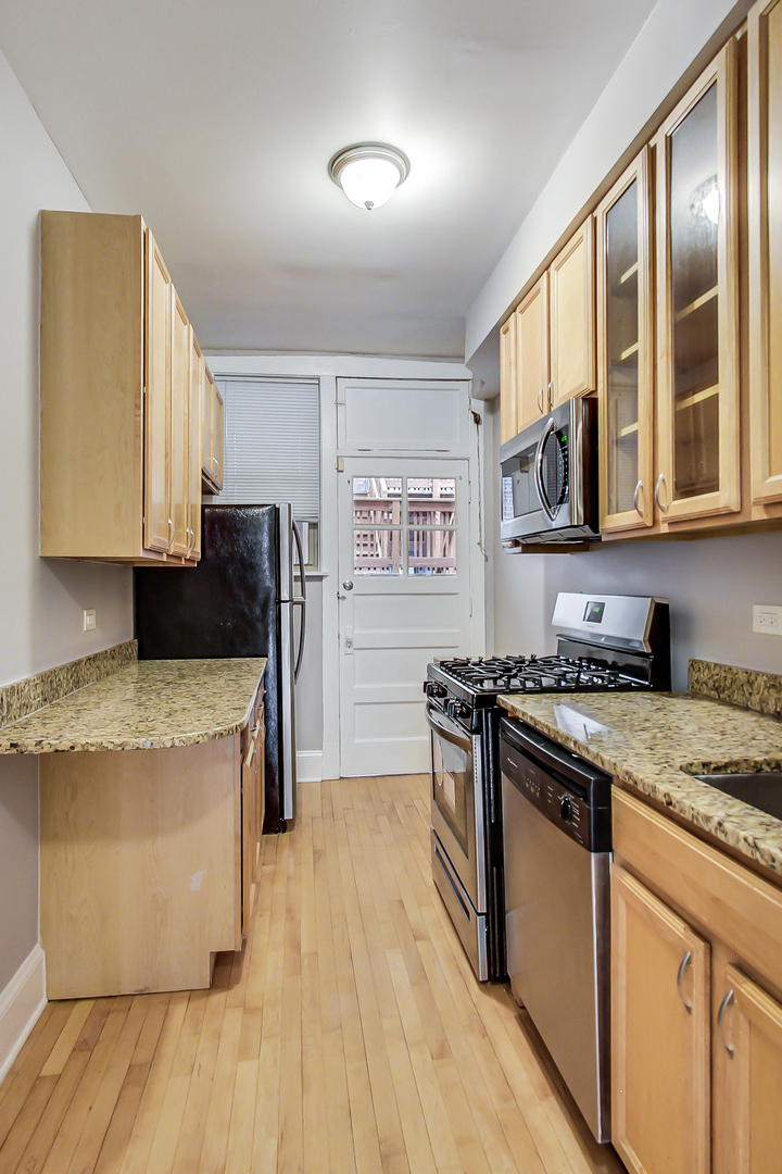 932 Pleasant Street, Unit 2W Oak Park, IL 60302 - Photo 10 of 21 a kitchen with stainless steel appliances granite countertop a stove and a refrigerator