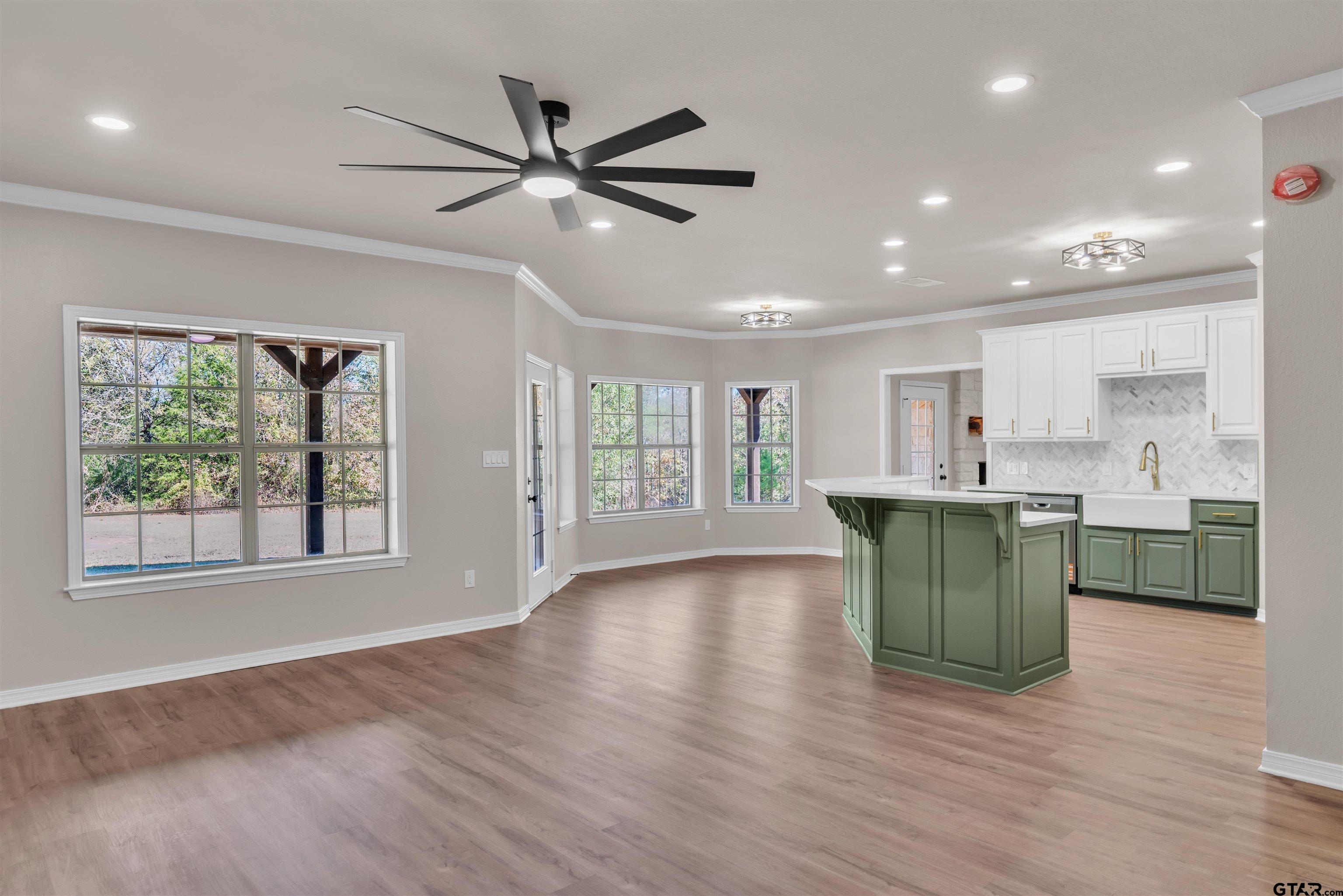 7589 Weeping Willow Road Big Sandy, TX 75755 - Photo 11 of 48 a view of an empty room with a kitchen and a window