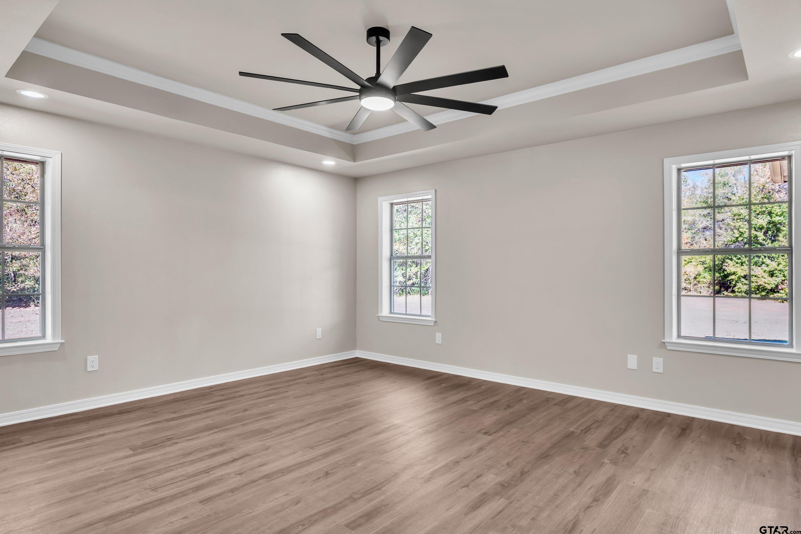 7589 Weeping Willow Road Big Sandy, TX 75755 - Photo 17 of 48 a view of a big room with wooden floor and windows