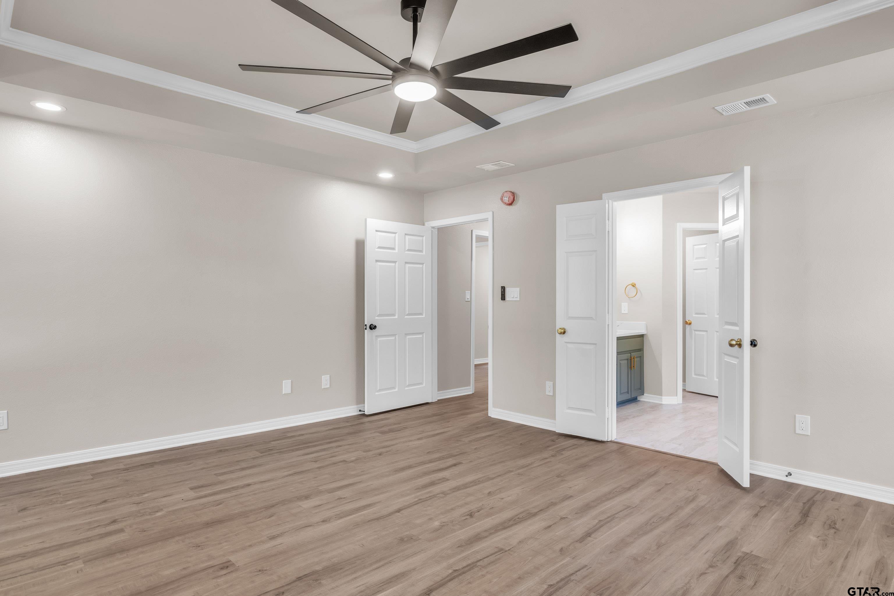 7589 Weeping Willow Road Big Sandy, TX 75755 - Photo 18 of 48 an empty room with wooden floor and a ceiling fan