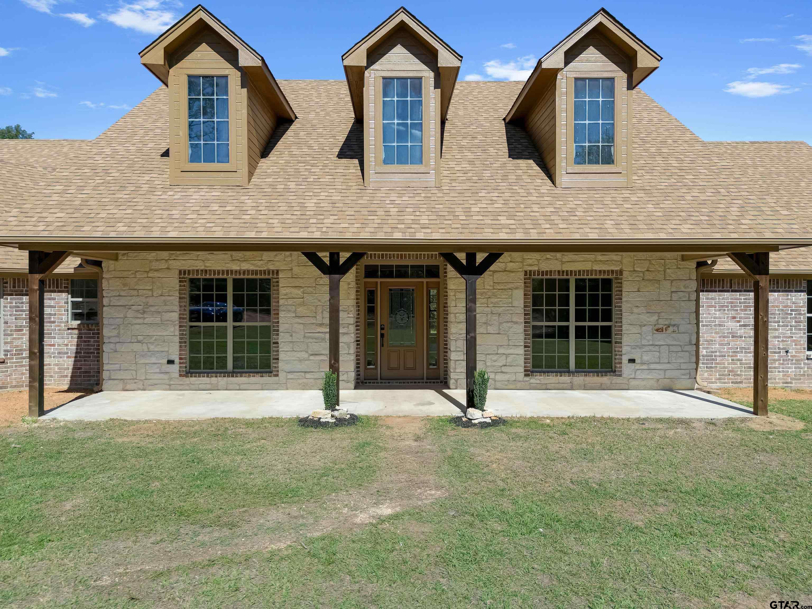 7589 Weeping Willow Road Big Sandy, TX 75755 - Photo 2 of 48 a front view of brick house with a yard