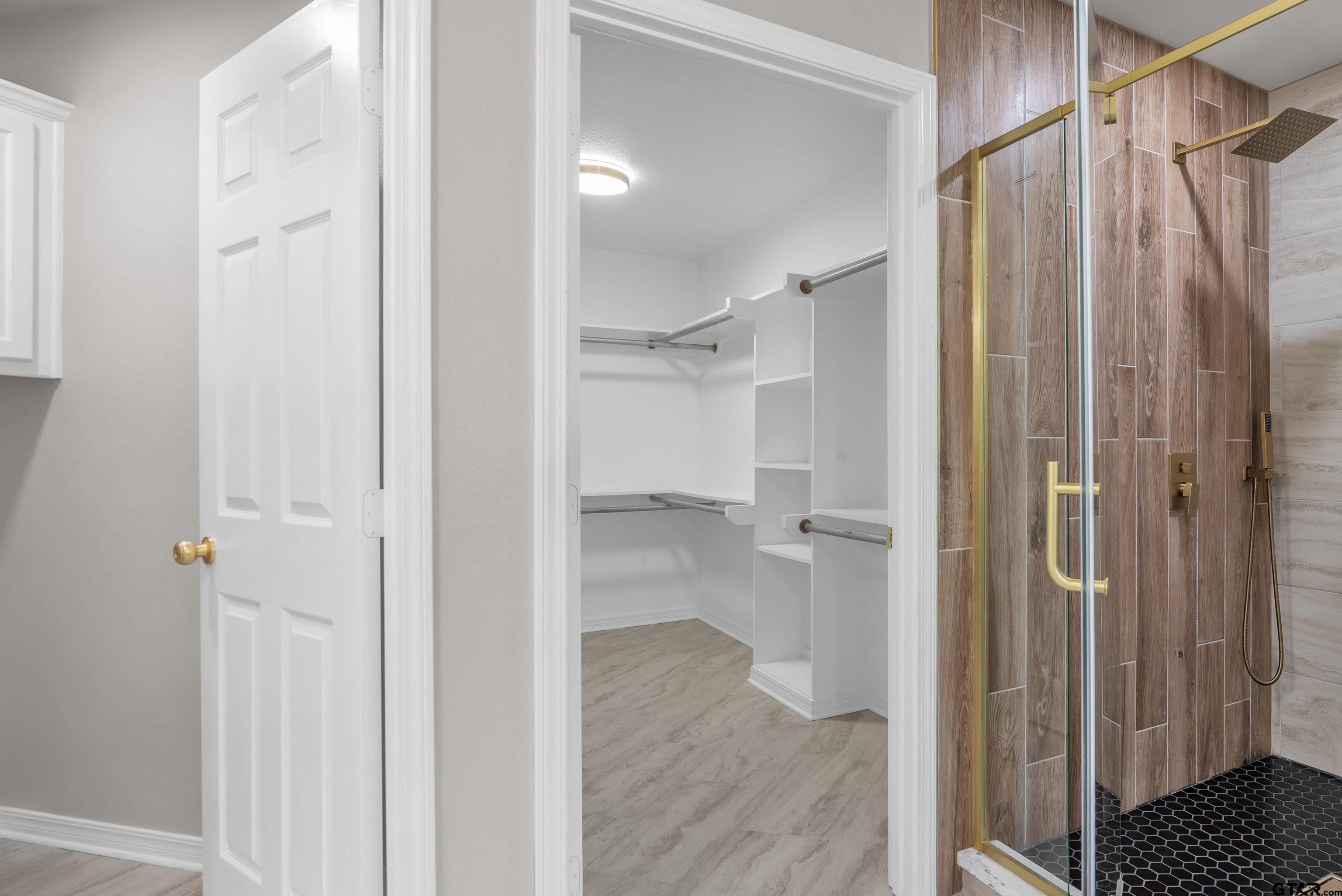 7589 Weeping Willow Road Big Sandy, TX 75755 - Photo 21 of 48 a bathroom with a shower and a glass door