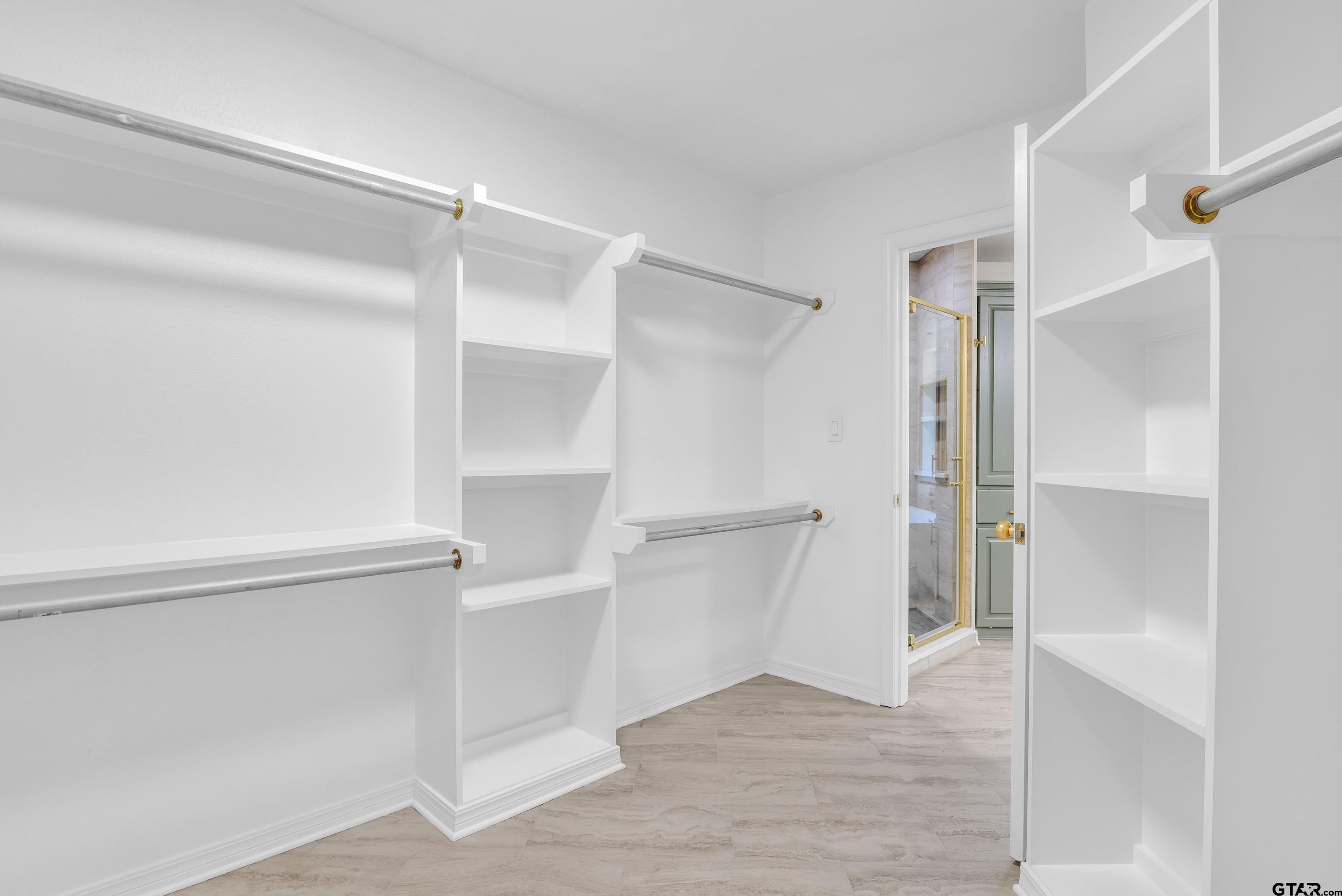 7589 Weeping Willow Road Big Sandy, TX 75755 - Photo 22 of 48 a view of walk in closet with empty racks