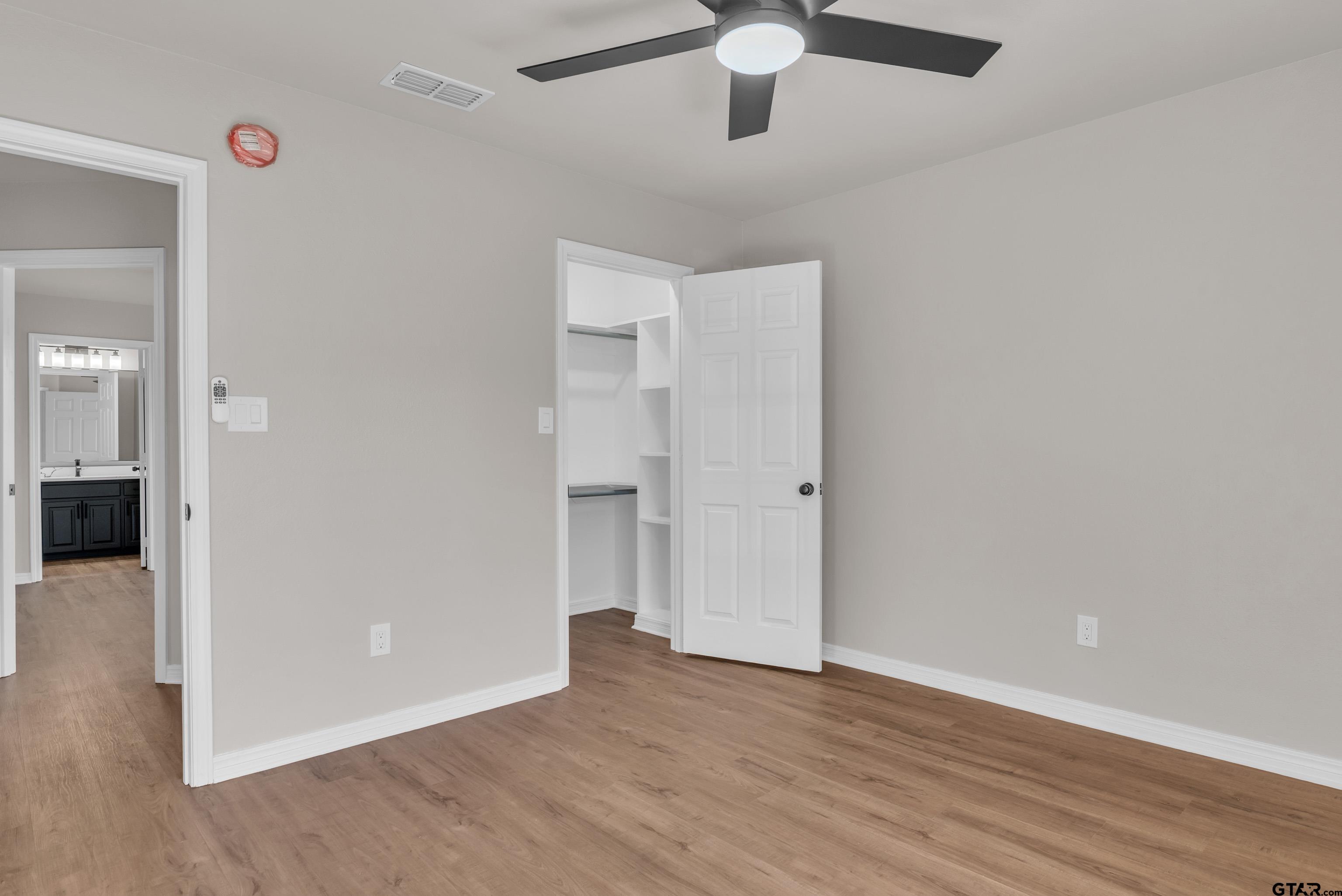 7589 Weeping Willow Road Big Sandy, TX 75755 - Photo 24 of 48 wooden floor in an empty room
