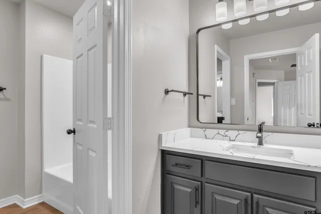 a bathroom with a double vanity sink a mirror and a shower