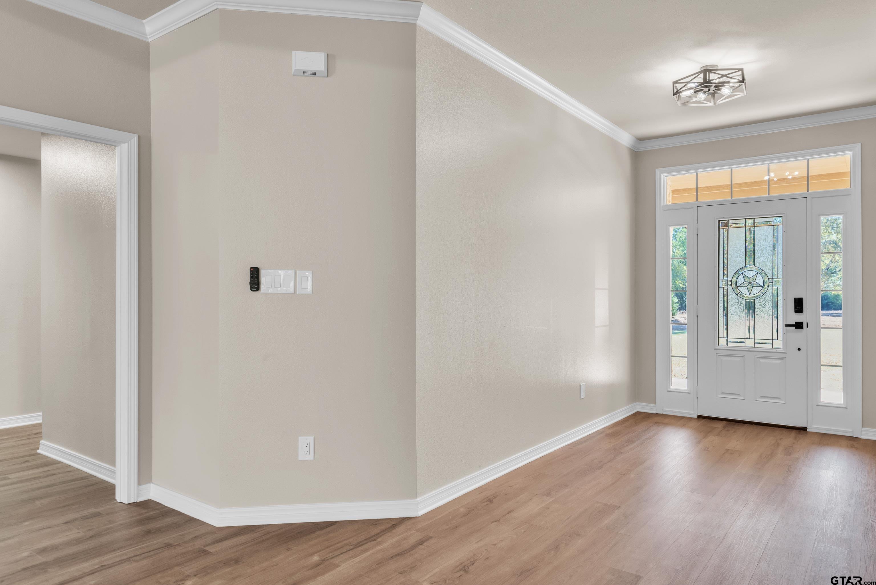 7589 Weeping Willow Road Big Sandy, TX 75755 - Photo 3 of 48 an empty room with wooden floor and windows