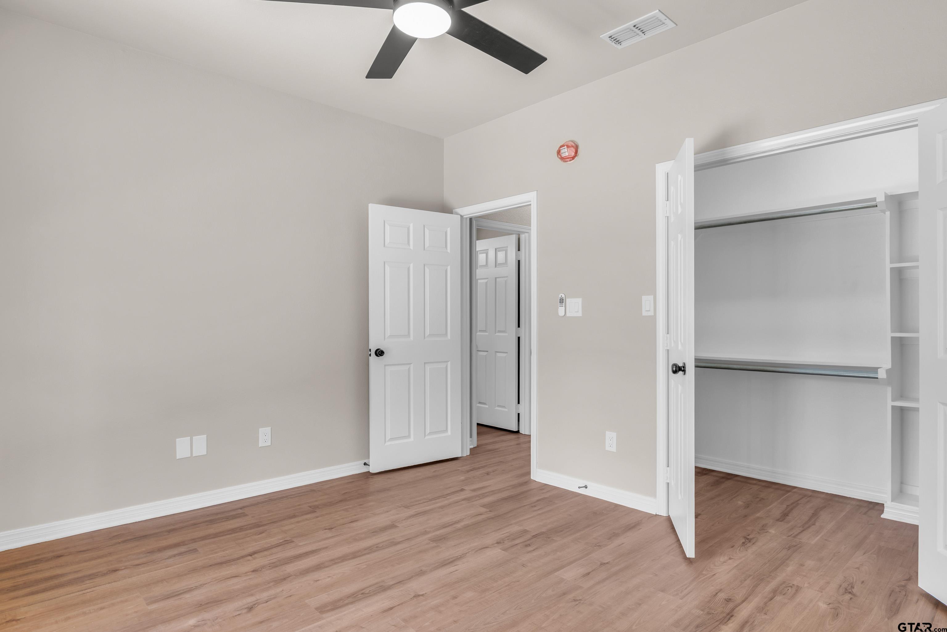 7589 Weeping Willow Road Big Sandy, TX 75755 - Photo 35 of 48 an empty room with wooden floor closet and windows