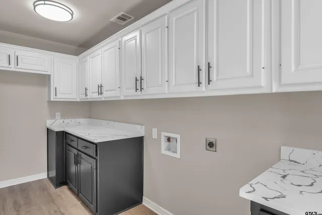 a kitchen with granite countertop white cabinets and sink