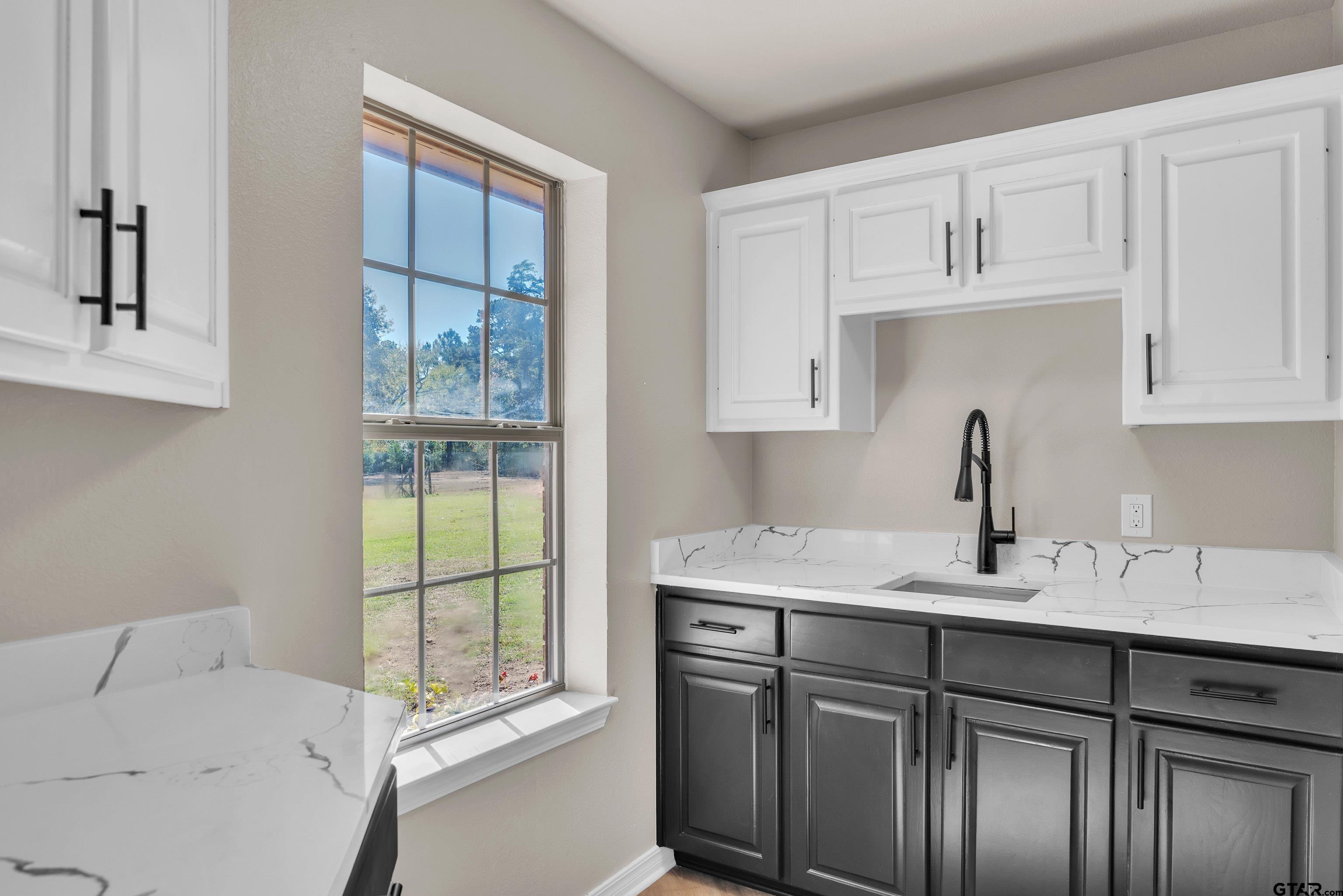 7589 Weeping Willow Road Big Sandy, TX 75755 - Photo 38 of 48 a kitchen with a sink cabinets and window