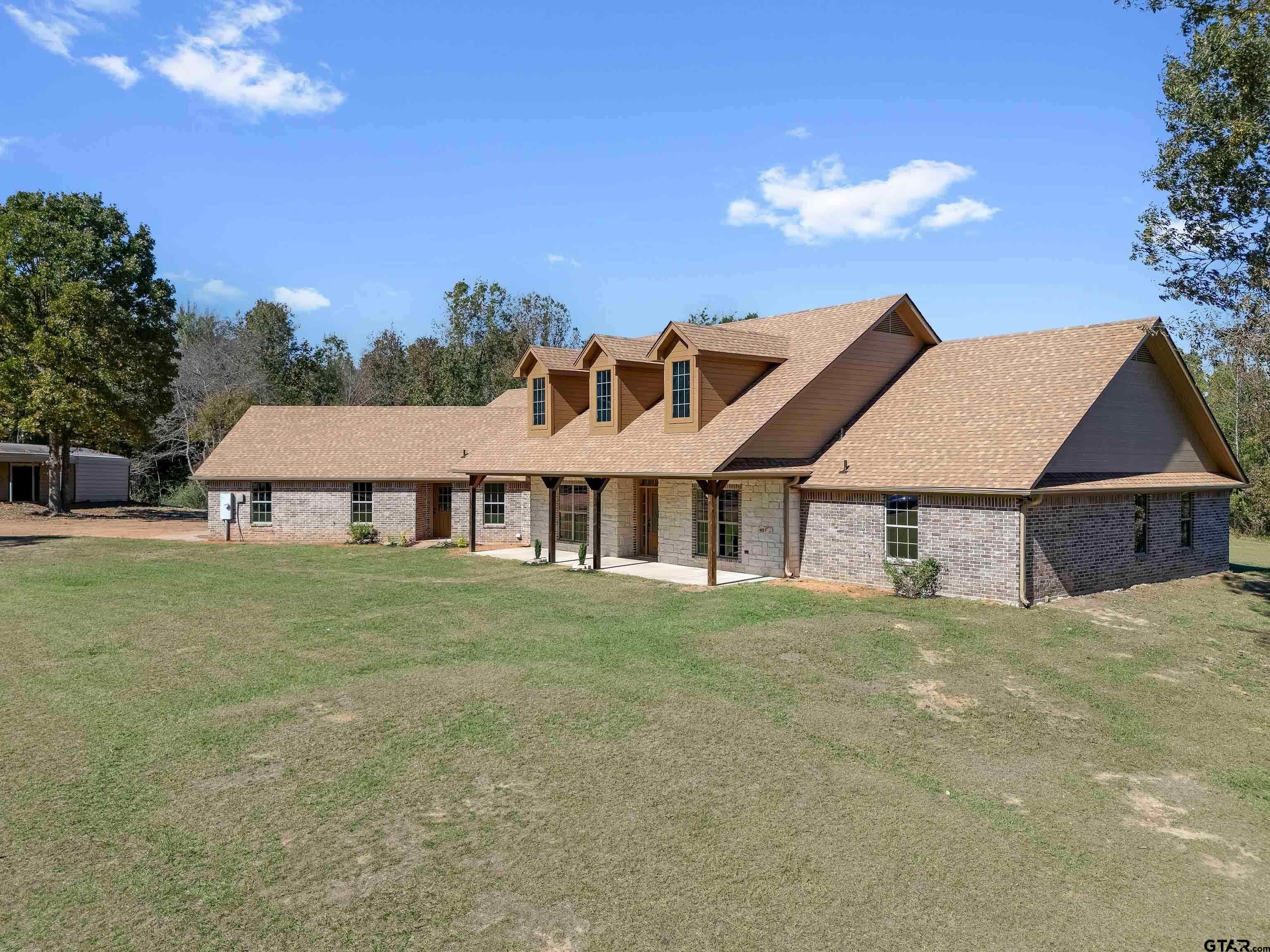 7589 Weeping Willow Road Big Sandy, TX 75755 - Photo 44 of 48 a front view of a house with a garden
