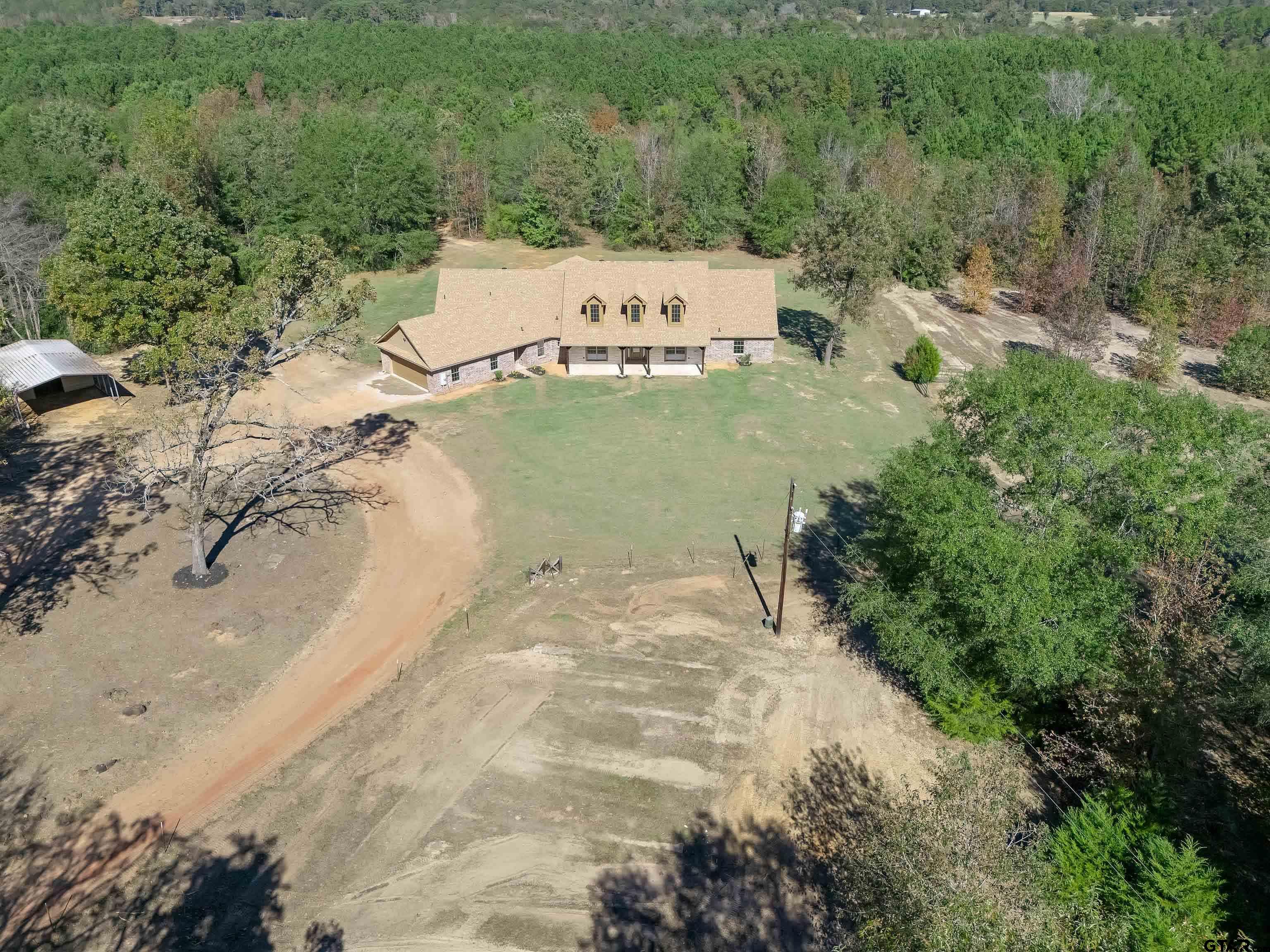 7589 Weeping Willow Road Big Sandy, TX 75755 - Photo 46 of 48 a view of a white house with a yard