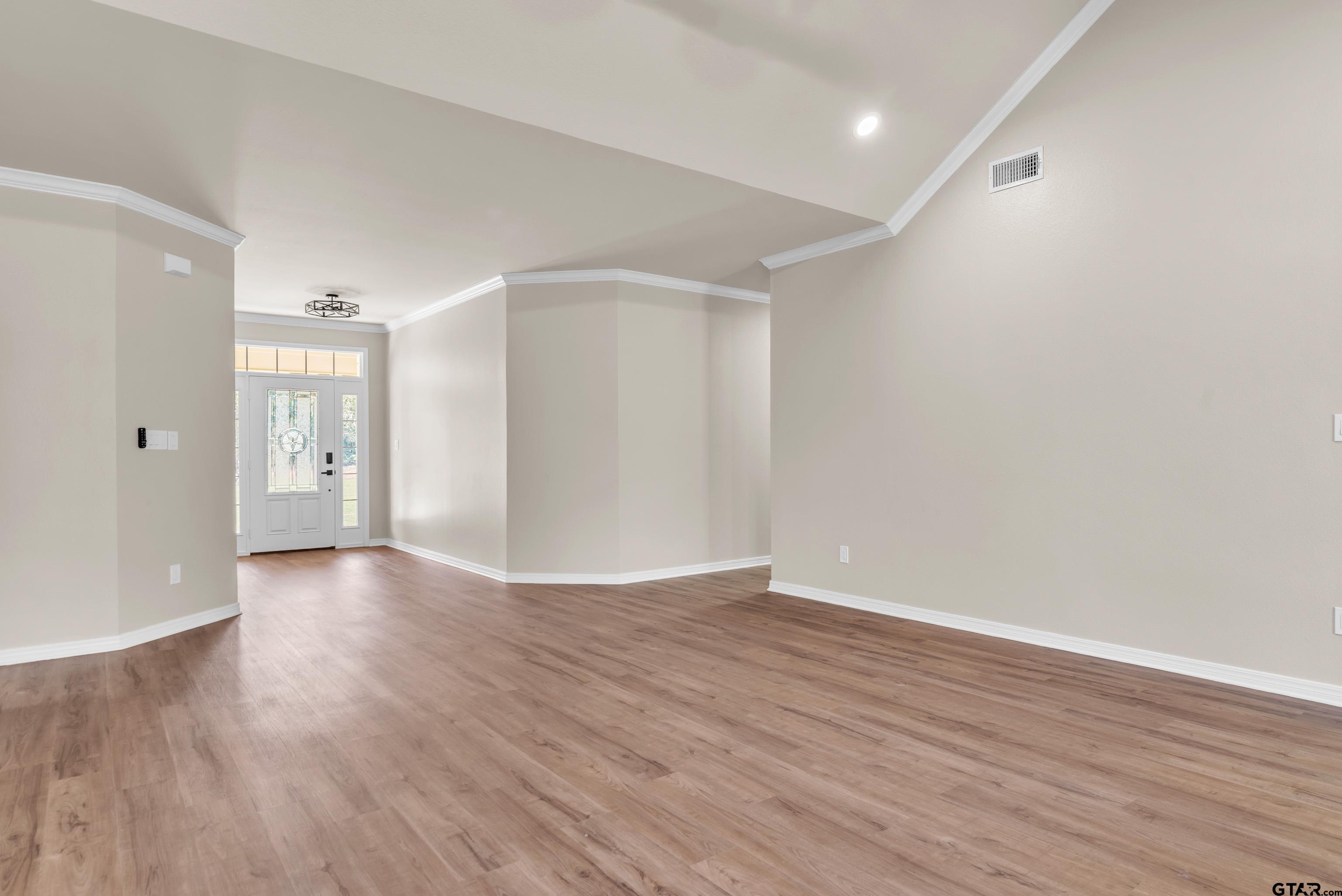 7589 Weeping Willow Road Big Sandy, TX 75755 - Photo 6 of 48 a view of an empty room with wooden floor