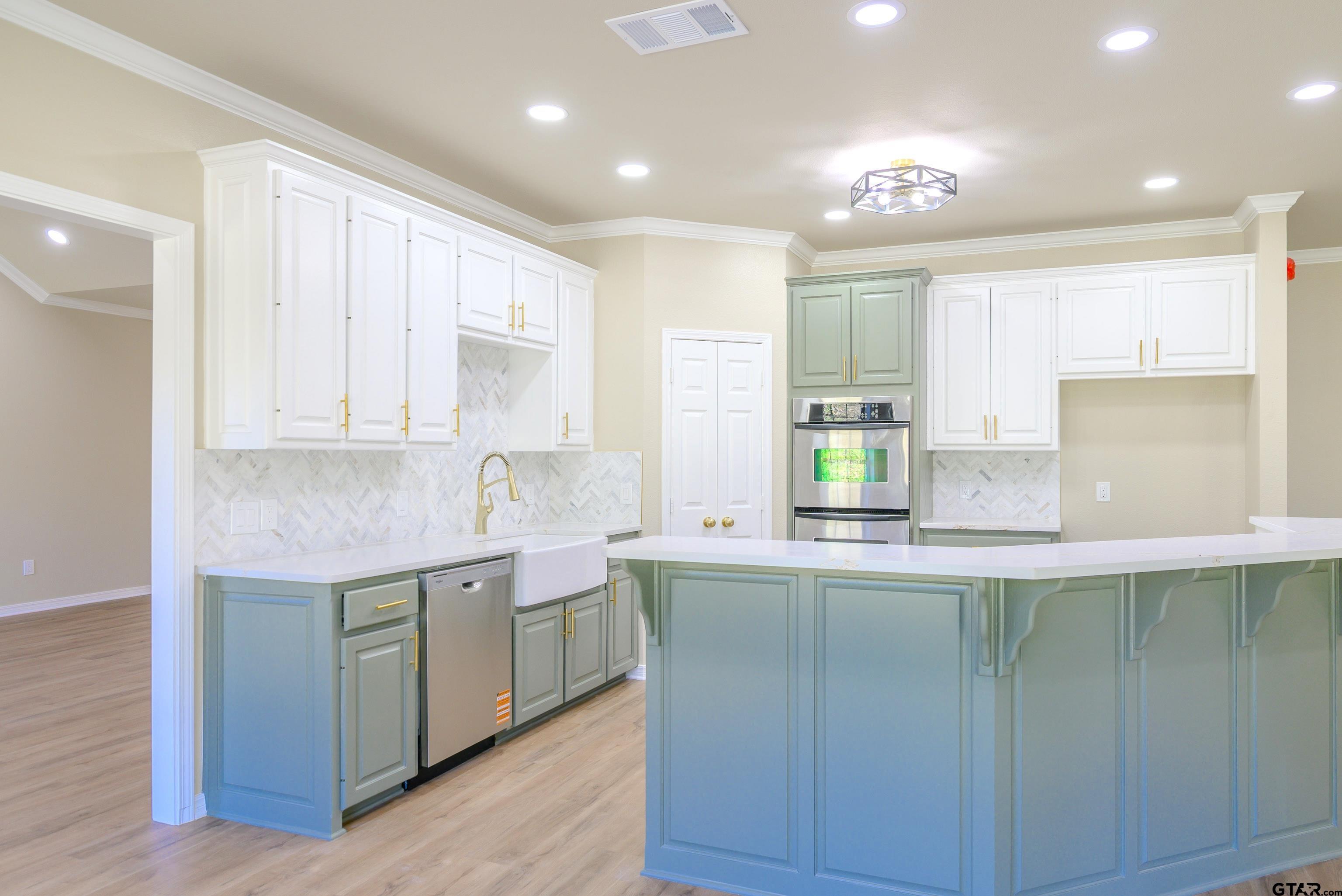7589 Weeping Willow Road Big Sandy, TX 75755 - Photo 9 of 48 a kitchen with kitchen island granite countertop a sink and cabinets