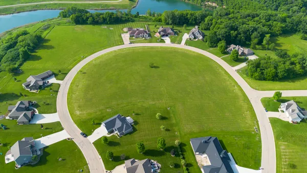 a view of a swimming pool with a yard