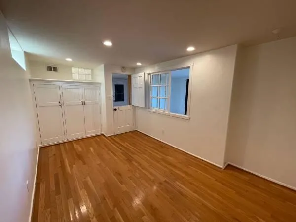a view of an empty room and wooden floor