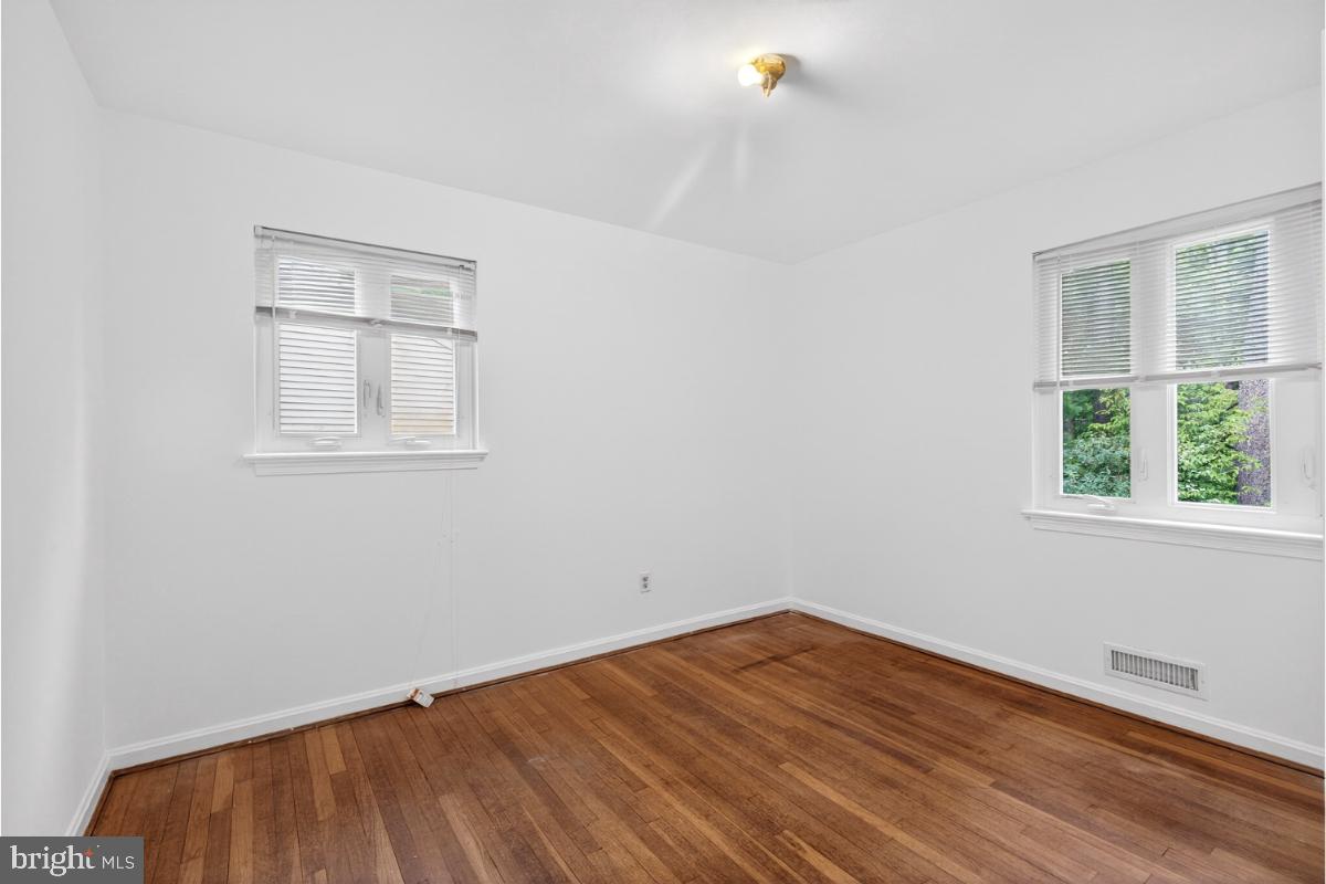 4068 Adams Drive Silver Spring, MD 20902 - Photo 13 of 43 an empty room with wooden floor and windows