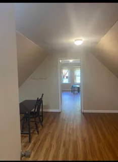 a view of a room with wooden floor and chair