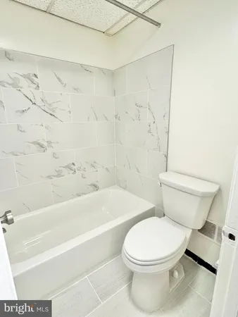 a bathroom with a shower and a sink