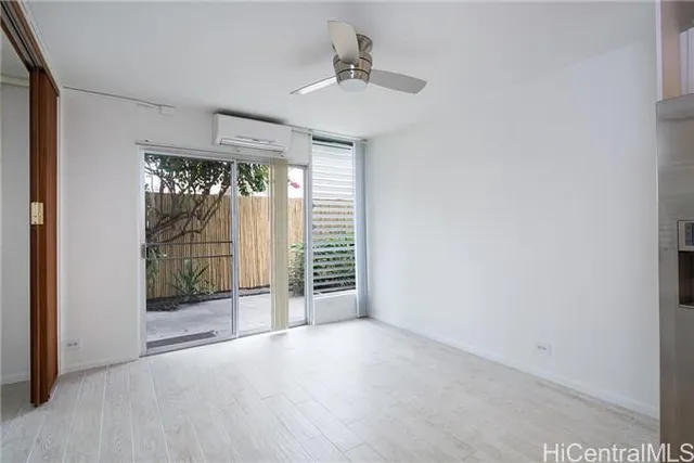 a view of an empty room with glass door