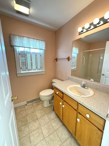 a bathroom with a sink a toilet and mirror