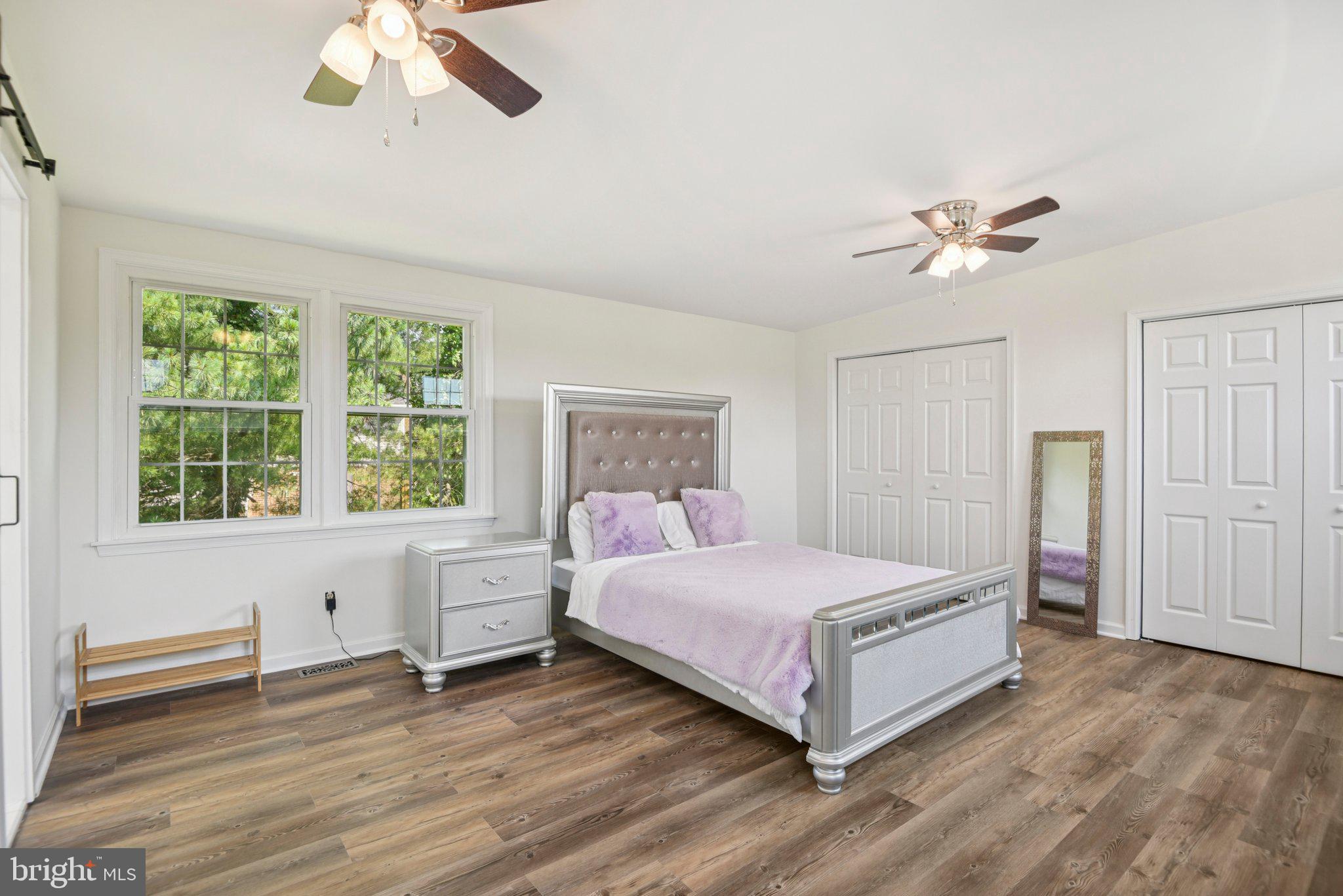 1005 Kings Tree Drive Bowie, MD 20721 - Photo 15 of 71 a bedroom with a bed and a chandelier