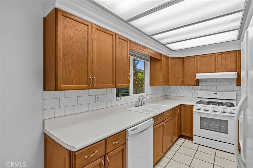 2994 Bautista Street Riverside, CA 92506 - Photo 14 of 37 a kitchen with a sink stove and cabinets