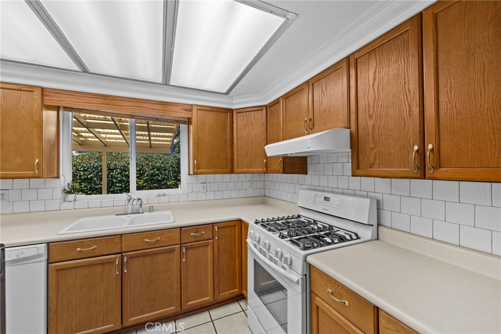 2994 Bautista Street Riverside, CA 92506 - Photo 15 of 37 a kitchen with granite countertop cabinets stainless steel appliances and sink