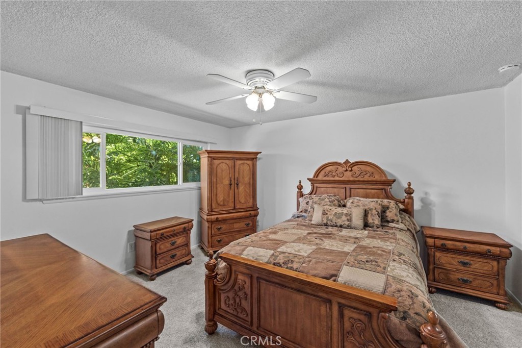 2994 Bautista Street Riverside, CA 92506 - Photo 20 of 37 a bedroom with a bed and a chandelier