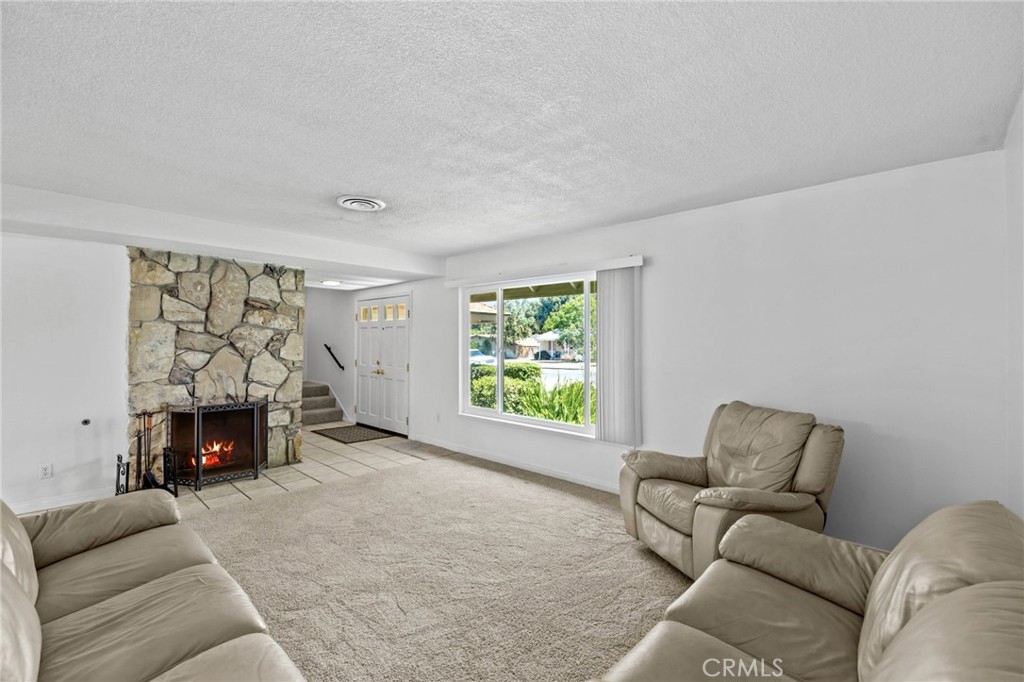 2994 Bautista Street Riverside, CA 92506 - Photo 8 of 37 a living room with furniture a window and a fireplace
