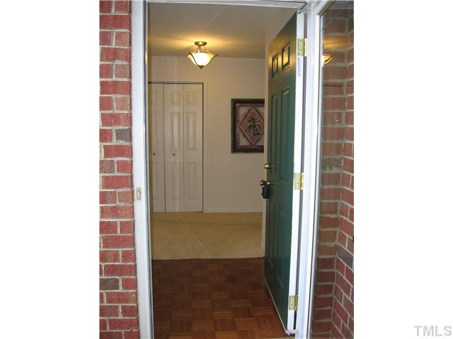 4211 Wellington Ridge Loop Cary, NC 27518 - Photo 2 of 22 Gracious formal foyer features updated lighting, wood flooring, coat closet (on the left) plus larger storage closet to the right. Additional outdoor storage closet is by the back patio. Handicap accessible Foyer