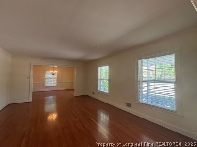 1513 Raeford Road Fayetteville, NC 28305 - Photo 4 of 25 an empty room with wooden floor and windows
