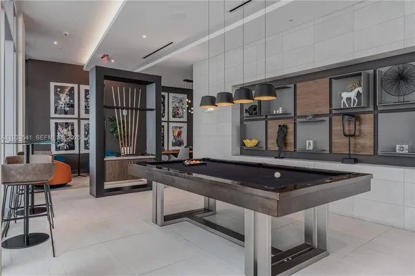 a kitchen with stainless steel appliances granite countertop a sink and a refrigerator