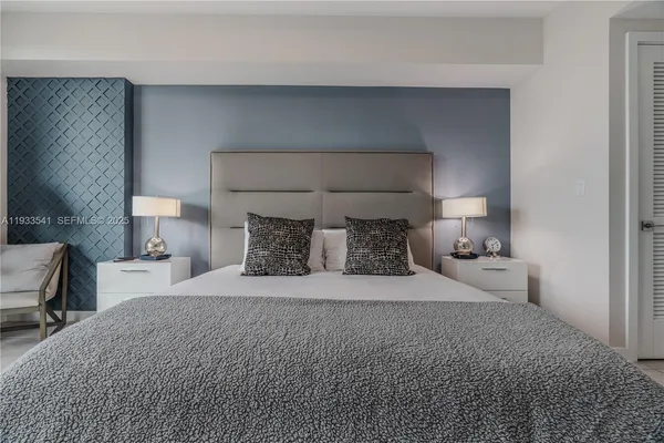 a bedroom with a bed and a lamp