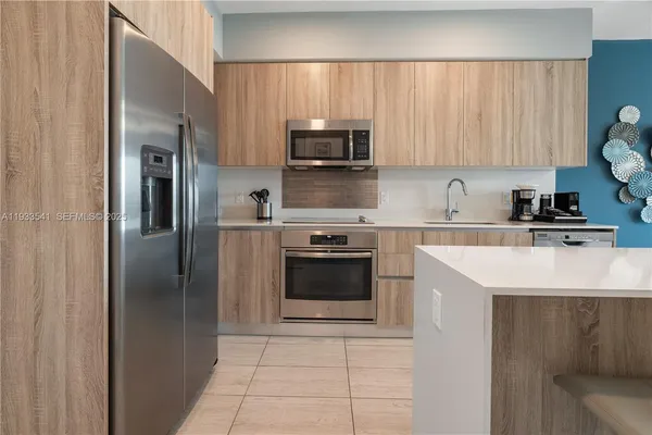 a kitchen with a sink a stove and refrigerator