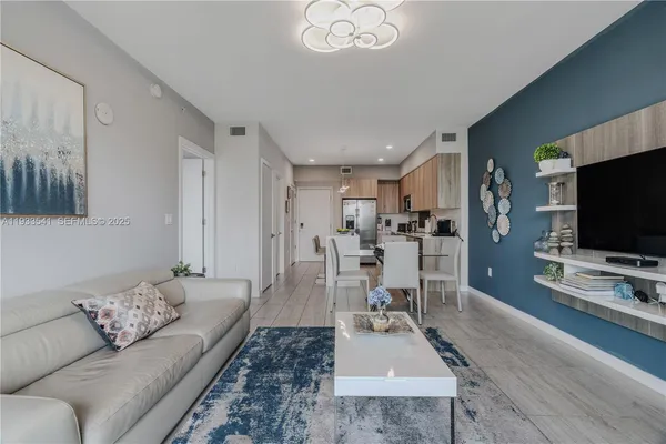 a living room with furniture and a flat screen tv