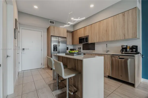 a kitchen with a refrigerator a sink and cabinets