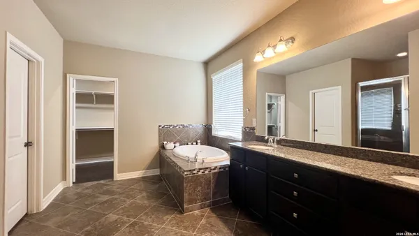 an empty room with a chandelier fan