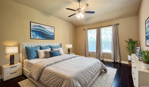 a bedroom with a large bed and a chandelier