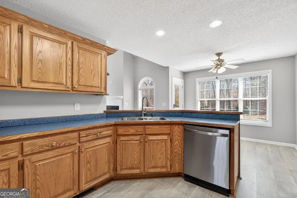 a kitchen with sink and cabinets