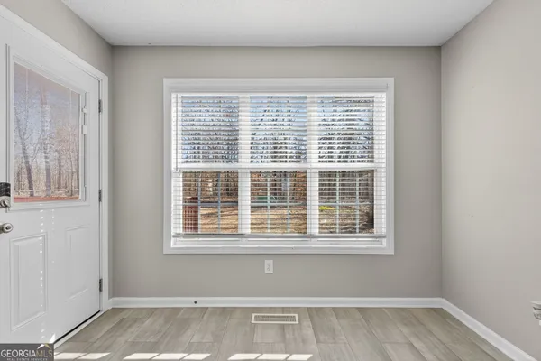 a view of a room with wooden floor and windows