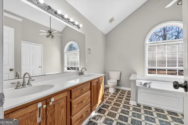 a spacious bathroom with a double vanity sink mirror and toilet