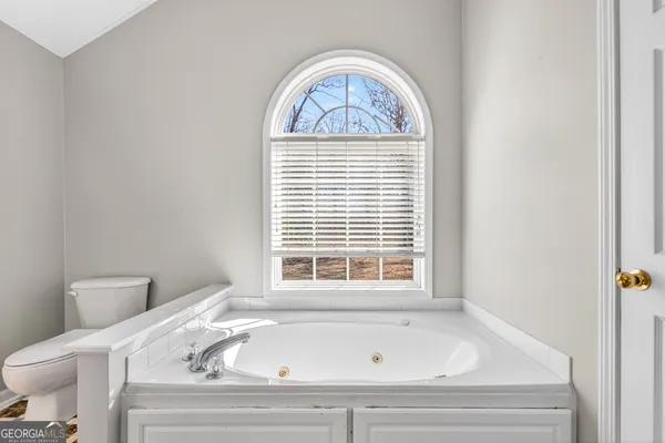 a bathroom with a bathtub and window