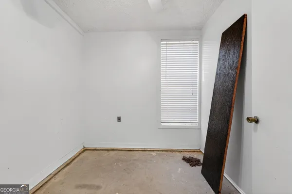 a view of an empty room with a window