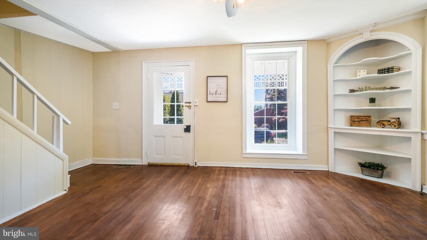 4564 Durham Road, Unit B Doylestown, PA 18902 - Photo 5 of 13 a view of an empty room with wooden floor and a window