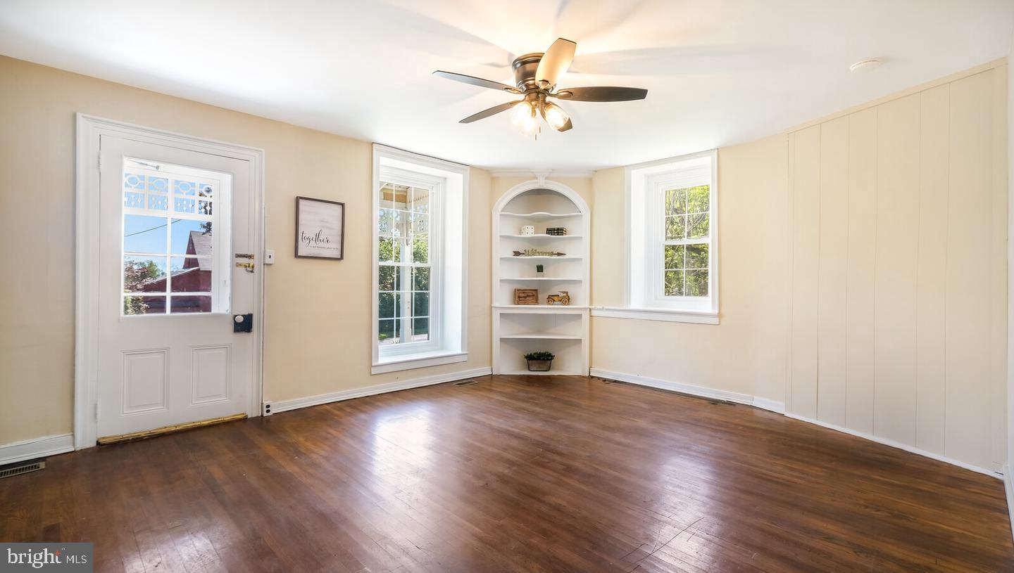 4564 Durham Road, Unit B Doylestown, PA 18902 - Photo 6 of 13 a view of an empty room with a window and wooden floor