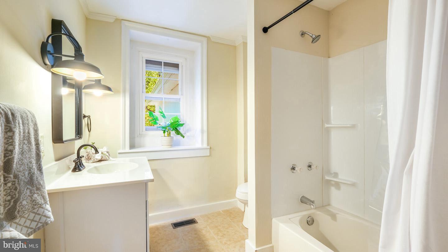 4564 Durham Road, Unit B Doylestown, PA 18902 - Photo 7 of 13 a bathroom with a bathtub shower sink and mirror