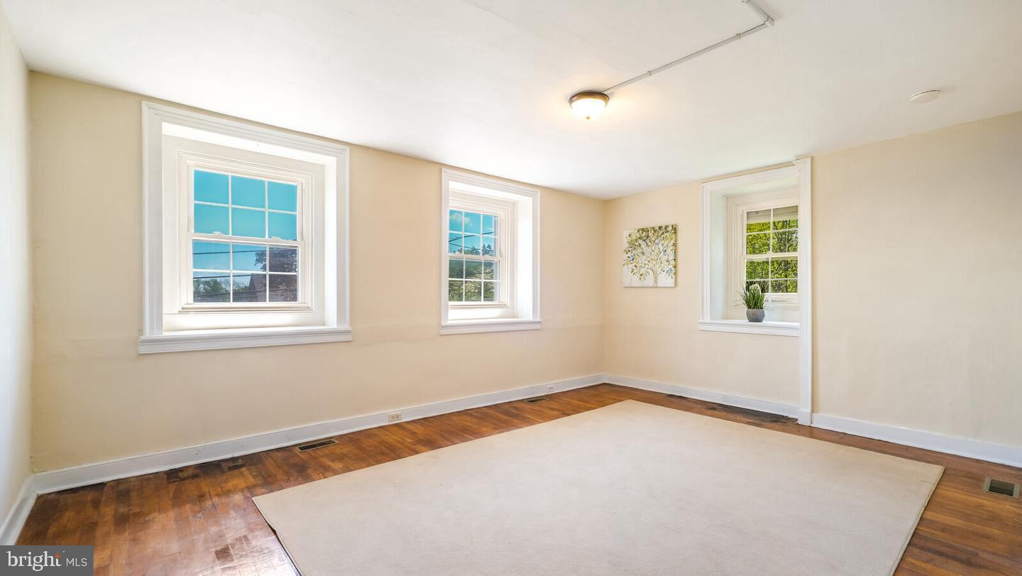 4564 Durham Road, Unit B Doylestown, PA 18902 - Photo 9 of 13 an empty room with windows