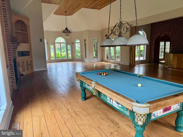 a living room with fireplace furniture and a wooden floor